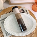 Detail of high-elastic seamless hair ties in a clear cylinder jar on a white ceramic plate - Jar / Gradient Coffee