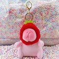 Plush pink capybara keychain with a red strawberry hat and gold metal clasp - Strawberry Hat Pink + Gold Clip