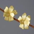 Artistic golden floral petal stud earrings with brushed texture on a wooden branch - Gold