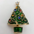 Close-up of golden Christmas tree brooch with green enamel and colorful gemstones - Green Enamel Tree with Gold Dots