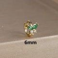 Macro view of a 6mm golden butterfly ear cuff with green marquise and white round stones - 6mm / Gold-Green