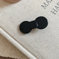 Close-up of black resin bow hair clip featuring a minimalist square wer wer letter engraving - Geometric Bow Style / Black / Small