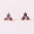 Three-petal flower stud earrings with purple zircons on a warm white stone base - Purple