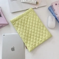 Quilted light green laptop sleeve with diamond patterns and woven brand label details - Bright yellow