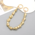 Detailed view of the gold irregular beaded handle chain with round spring buckles - Irregular Pebble Metal Texture / Gold