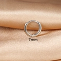 Detail showing 7mm diameter minimalist huggie earrings on champagne satin background - 1PC / 7mm / Silver
