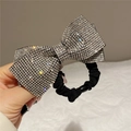 Close-up of oversized rhinestone bow hair tie with sparkling crystals and black elastic band - Style A Scrunchie / White