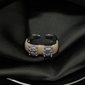 Detailed macro view of an adjustable silver ring with beige enamel and purple gemstones - Adjustable Open / Beige Enamel Purple Gem