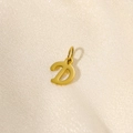 Detailed view of a 14K gold-plated letter D pendant on light textured fabric - Letter-D