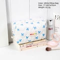 White quilted bow makeup bag with blue heart patterns and pearl zipper detail - White Pillow Bag