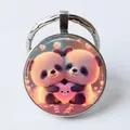 Round alloy keychain with cute cartoon pandas holding hearts and metallic frame - Cartoon Pandas/Pink Heart