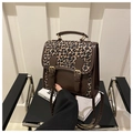 Detail of leopard print crossbody bag featuring gold hardware and vintage PU leather finish - Coffee