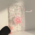 Detailed close-up of clear iPhone case featuring 3D pink flowers and pearl decorations - Pink Core Floral + Pink Flower Bracket / iPhone 15 Pro Max
