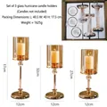 Three-piece set of gold metal candle holders with light brown glass shades in varying heights - 3-Piece Set (No Candle) / Dreamy Gold