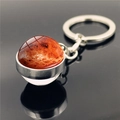 Close-up of double-sided glass planet keychain with detailed Mars pattern and silver base - Golden Orange Planet