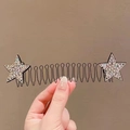 Close-up of wavy black hair comb with sparkling rhinestone stars for styling hair - Silver Star Spring Comb