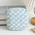 Close-up of blue and white checkered knitted cosmetic bag with zipper on a wooden desk - Blue & White Plaid