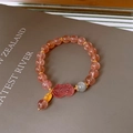 Close-up of strawberry quartz beaded bracelet with pink Pi Xiu charm and golden accents - Pink Orange Pixiu Pendant Style (6#)