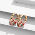 Close-up of gold enamel hoop earrings with red floral patterns on a white background - Red Background Pink Floral