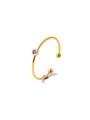 Detailed macro of gold plated ring with purple zircon stone and circular settings - Violet