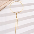 Detail view of a long gold snake chain necklace made of polished stainless steel - Gold