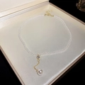 Macro detail of French vintage pearl necklace with golden cubic zirconia pendant and clasp - White Pearl Teardrop Pendant Necklace