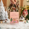 Pink Christmas gift box with reindeer print and gold rope handle for festive treats - Pink