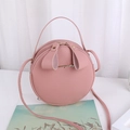 Pink round crossbody bag in lychee pattern faux leather with top handle and strap - Pink