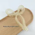 Matte jelly light yellow bow-shaped hair claw clip on wooden tray for women - Matte Jelly Light Yellow