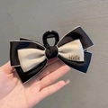 Large black and white bow hair claw clip with gold min letter decoration in hand - Letter Bow-Black Hair Clip