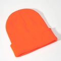Close-up of fluorescent orange knitted beanie showing detailed ribbed texture and wide cuff - Orange Red