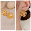 Vintage gold flower stud earrings with central pearl accents worn by a model - 34# Matte Gold Flower Pearl