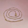 Detail of a minimalist gold satellite chain with small beads and adjustable lobster clasp - Gold Snake Satellite Chain