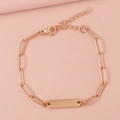 Detail view of rose gold stainless steel paperclip chain bracelet on pink fabric background - 1 Bar / Rose Gold