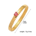 Detailed view of a gold stretch bracelet with heart-shaped red zircon stones and size info - Bracelet-Red