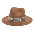 Detail of vintage brown straw fedora featuring ethnic beads, tassel, and turquoise stone - Coffee