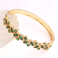 Macro detail of 18K gold plated geometric cuff featuring marquise cut green crystals - Green