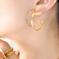 Twisted C-shape 18K gold plated titanium earrings and textured rings on model - 18K Gold / Gold