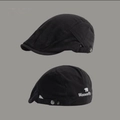 Detail of a black cotton beret featuring embroidered white Womenfly text and bear logo - Black Polar Bear