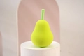 Pear-shaped green makeup sponge blender made of soft sponge on a white pedestal - Dark Green Pear