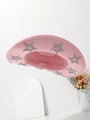Pink felt cowboy hat with silver sequin stars on the brim displayed with white decor - Pink