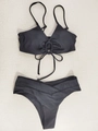 Flat lay of black bikini set featuring a V-neck halter top with ring detail and V-waist bottoms - S / Black