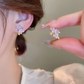 Close-up of purple enamel flower stud earrings showing fine metal detail and style - Purple Enamel Flower