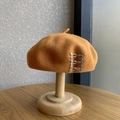 Camel wool beret with side silver metal buckles on a wooden display stand - M (56-58cm) / Silver Buckle - Khaki