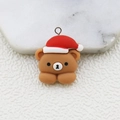 Macro view of a resin Christmas bear charm with a metal loop for DIY jewelry crafts - Bear with Christmas Hat