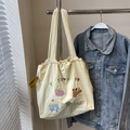 Beige canvas tote bag with puppy embroidery and drawstring closure on clothes hanger - PUPPYBABY Embroidery
