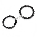 Detail of magnetic heart clasp connecting matte black and polished beaded bracelets - Shiny Black Lava White K Heart