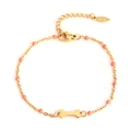 Golden stainless steel chain bracelet with pink beads and a bone pendant charm - Gold Bone - Pink Beads