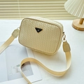 Cream white woven camera bag with a black and gold triangular logo and wide strap - Light Yellow