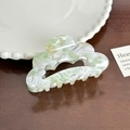 Pale green and white marble pattern cloud-shaped acetate hair claw clip on wood surface - Light Green Hollow Claw
